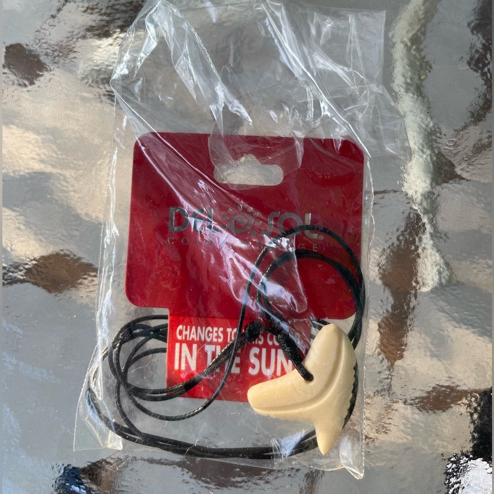 Del Sol New color changing shark tooth necklace ivory to orange in the sun